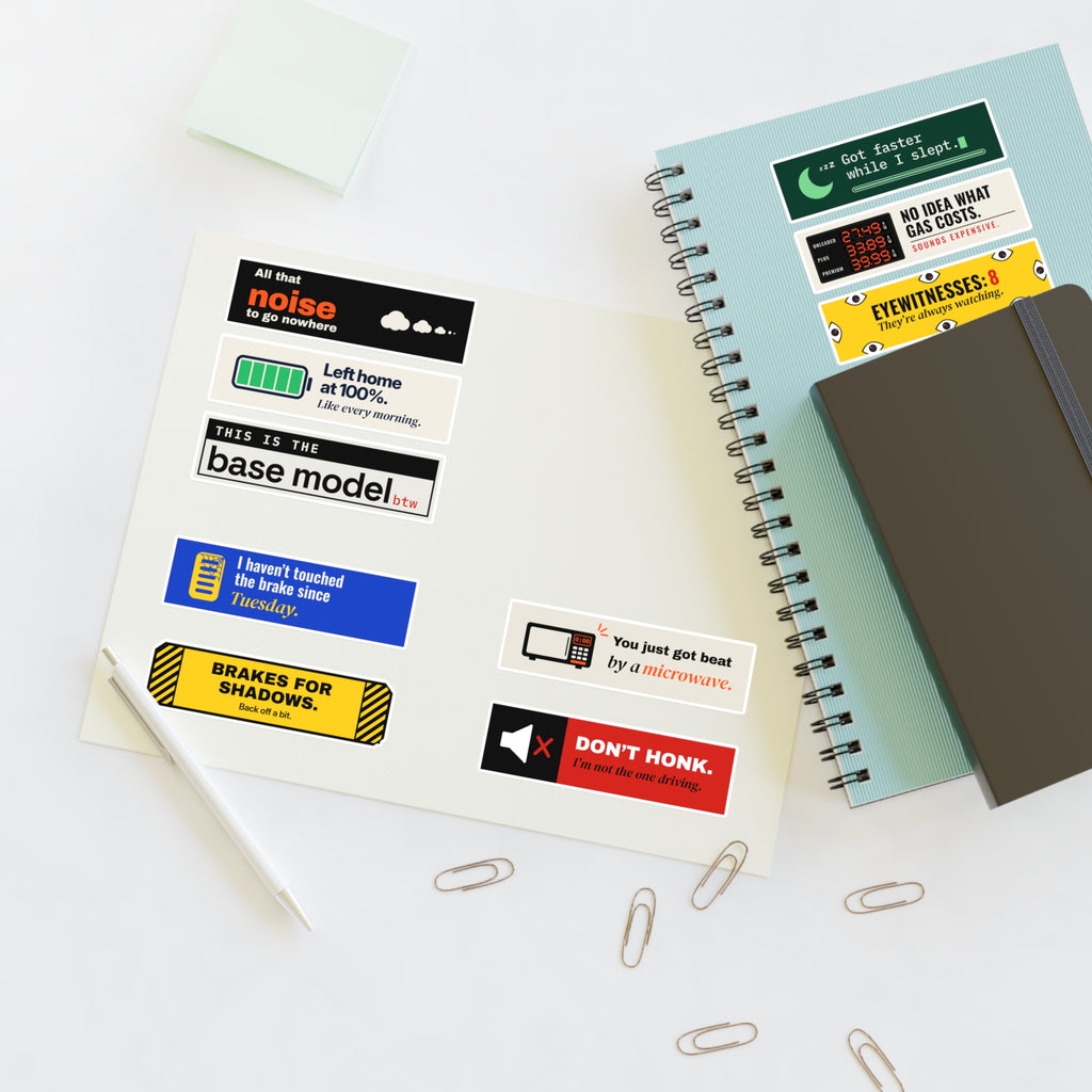 Mini 10-Pack (our picks), stickers on a desk with a notebook